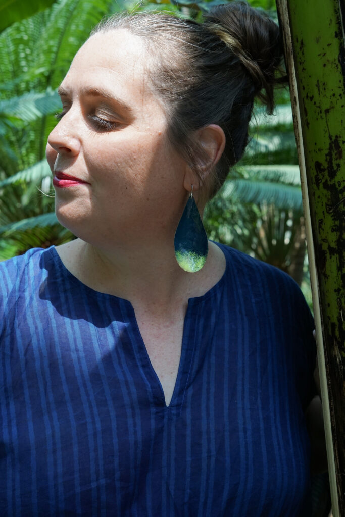 tropical vacation style: navy and neon statement earrings and navy kaftan