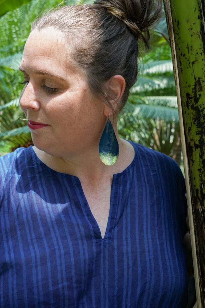 tropical vacation style: navy and neon statement earrings and navy kaftan