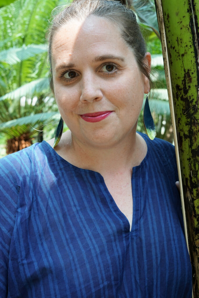 tropical vacation style: navy and neon statement earrings and navy kaftan