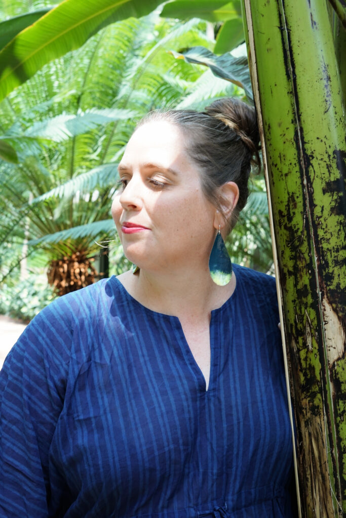 tropical vacation style: navy and neon statement earrings and navy kaftan