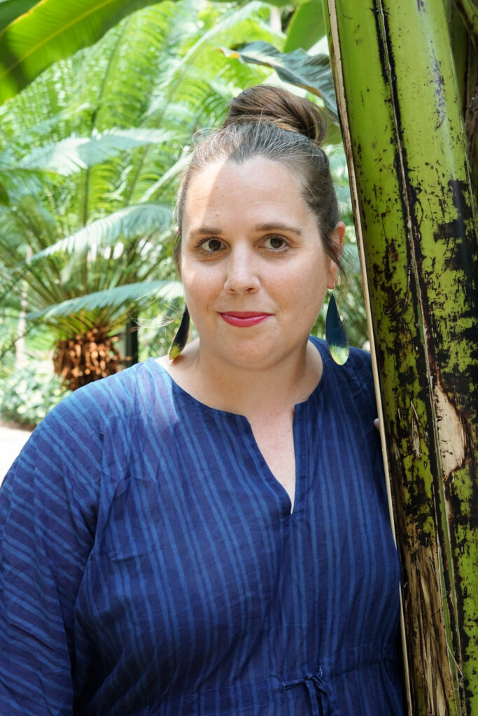 tropical vacation style: navy and neon statement earrings and navy kaftan