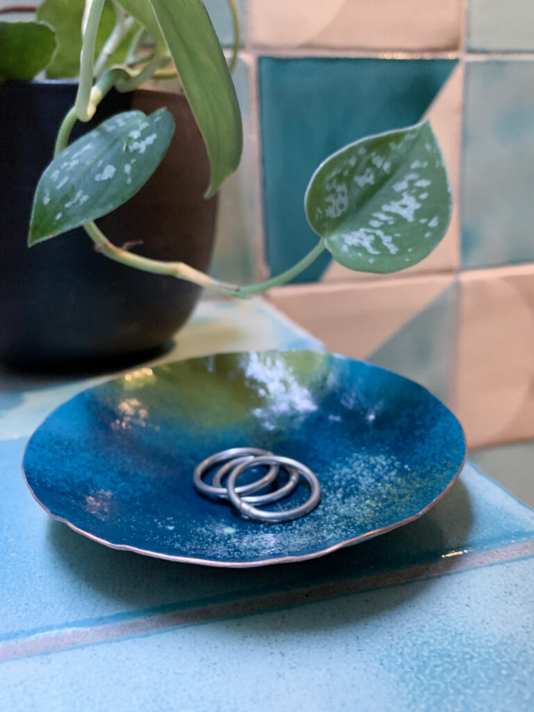 decorative metal jewelry dish with pothos