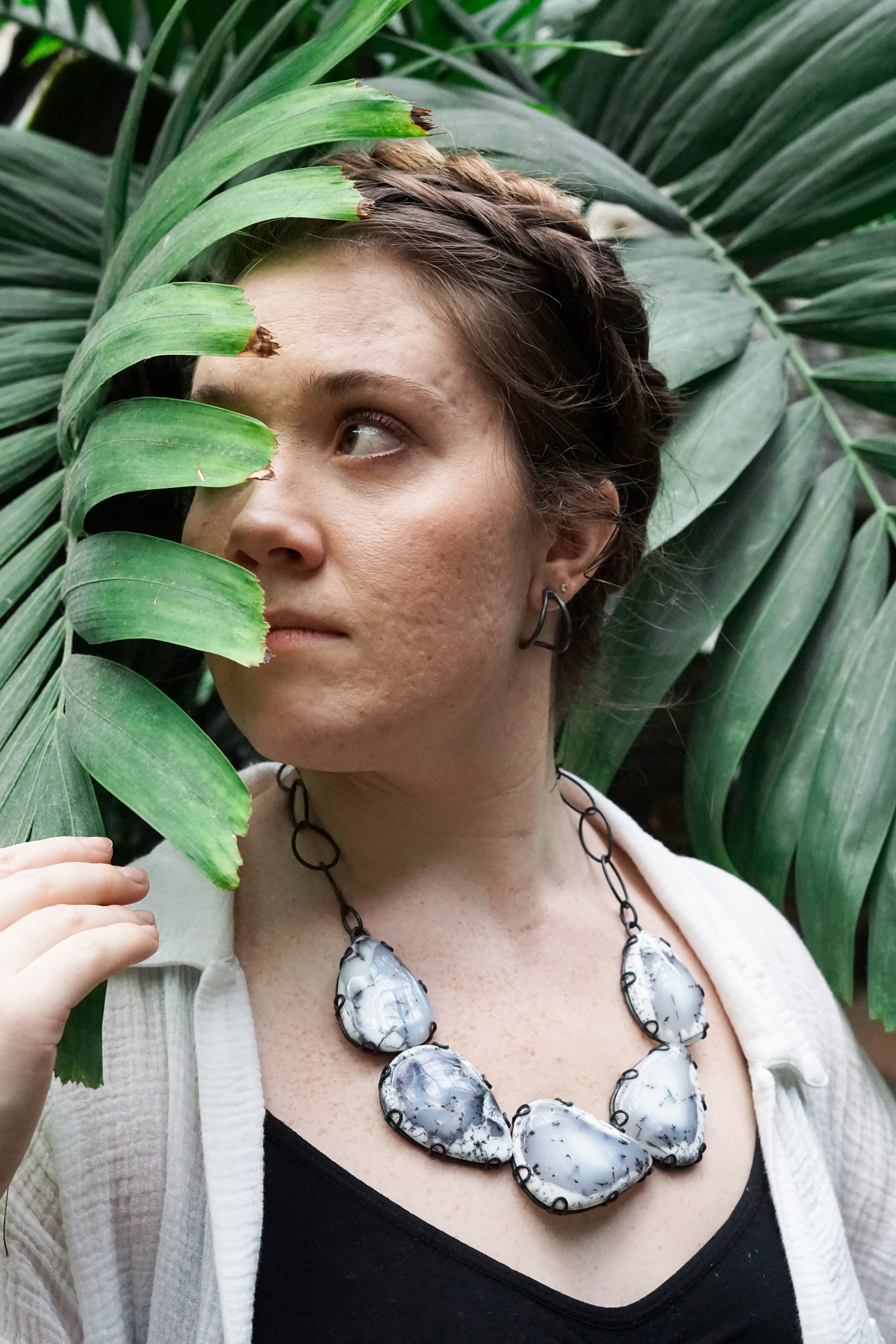 woman in garden with statement necklace